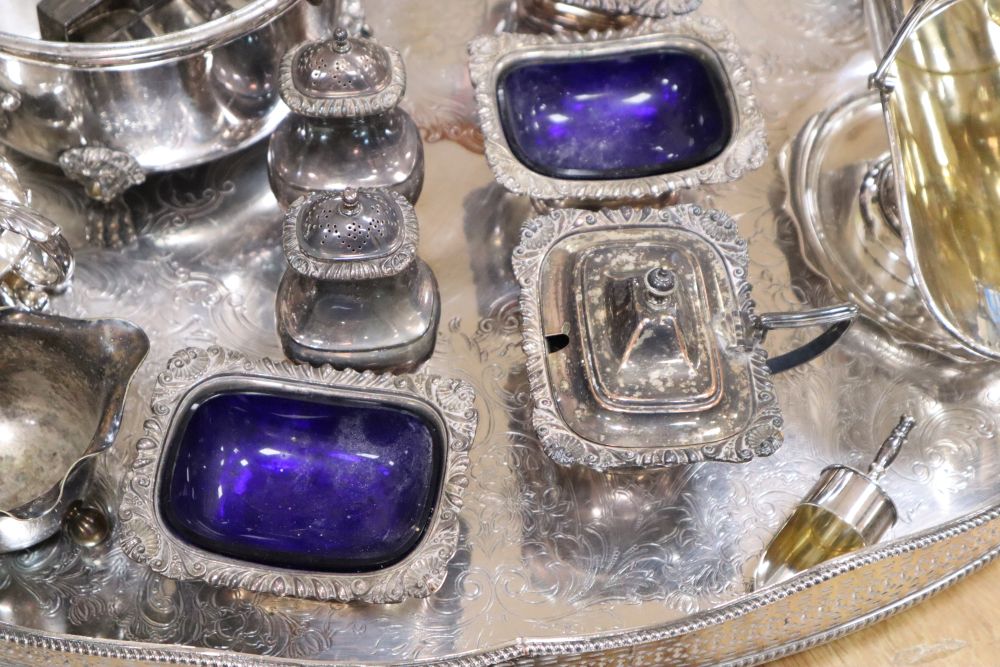 A large oval plated galleried tray and a collection of plated items,